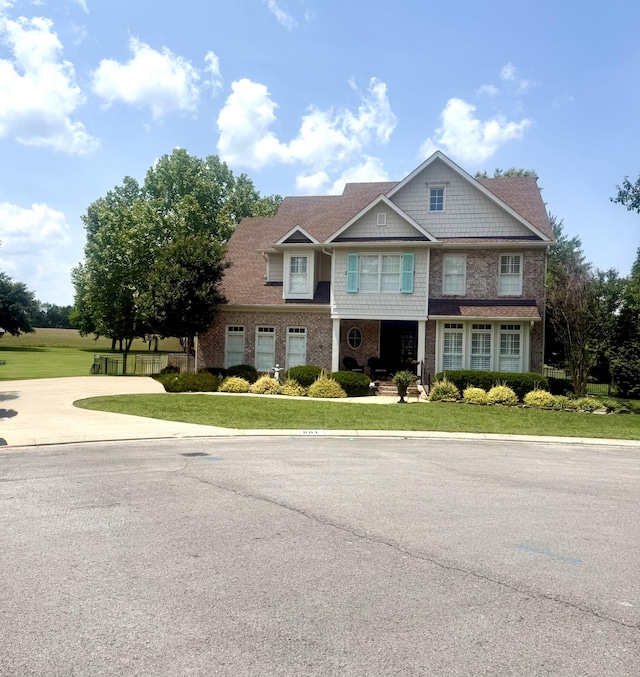 801 Peconic Pl, Murfreesboro, TN 37130 - view of front of property featuring a front lawn, brick siding, concrete driveway, and covered porch