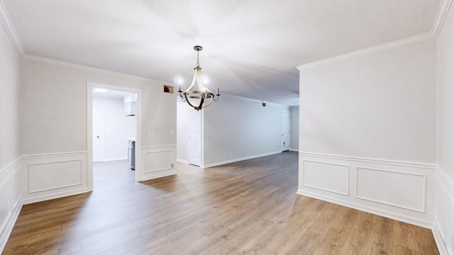 1280 Middle Tennessee Blvd Unit D6, Murfreesboro, TN 37130 - unfurnished room featuring a chandelier, light wood finished floors, crown molding, a wainscoted wall, and a decorative wall