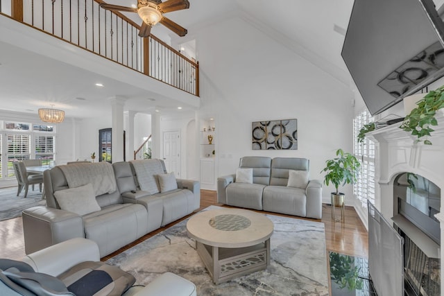 1918 Mosaic Trl, Murfreesboro, TN 37130 - living room with a towering ceiling, ceiling fan, decorative columns, wood finished floors, and a chandelier