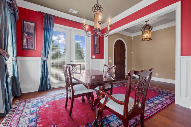 1638 Kelvington Blvd, Gallatin, TN 37066 - dining room featuring a chandelier, wood finished floors, ornamental molding, arched walkways, and wainscoting