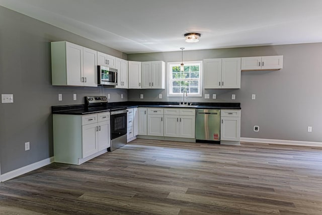 259 Longbranch Rd, Hohenwald, TN 38462 - kitchen with stainless steel appliances, dark countertops, a sink, and baseboards