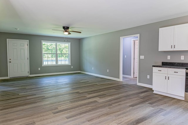 259 Longbranch Rd, Hohenwald, TN 38462 - unfurnished living room featuring ceiling fan, wood finished floors, and baseboards