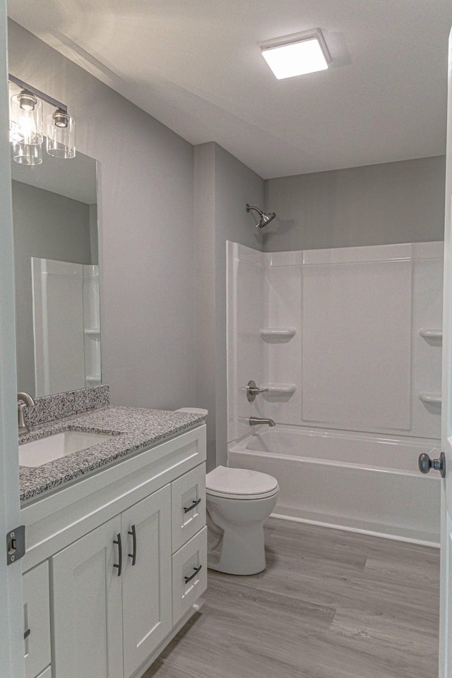 259 Longbranch Rd, Hohenwald, TN 38462 - full bath with toilet, vanity, wood finished floors, and shower / bathtub combination