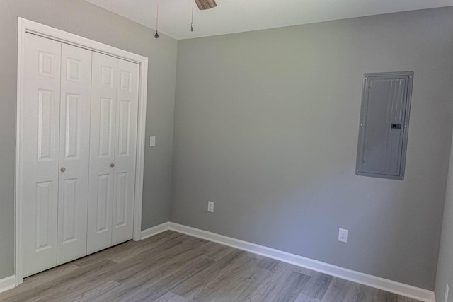 259 Longbranch Rd, Hohenwald, TN 38462 - unfurnished bedroom with electric panel, wood finished floors, a closet, and baseboards