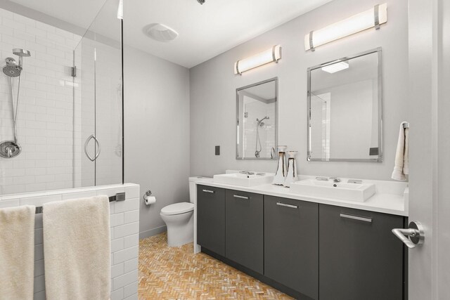 900 20th Ave S Unit 715, Nashville, TN 37212 - full bathroom with double vanity, toilet, and a tile shower