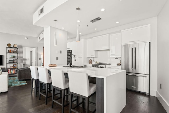 900 20th Ave S Unit 715, Nashville, TN 37212 - kitchen featuring high end refrigerator, a sink, a breakfast bar, dark wood-style floors, and recessed lighting