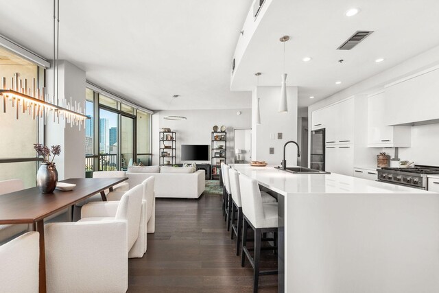 900 20th Ave S Unit 715, Nashville, TN 37212 - kitchen featuring a sink, dark wood-type flooring, white cabinetry, modern cabinets, and stove