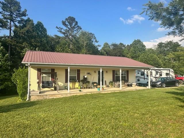 832 Fritzsche Loop, Jamestown, TN 38556 - view of front of property with a porch, a front yard, and metal roof