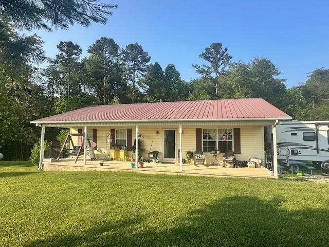 832 Fritzsche Loop, Jamestown, TN 38556 - rear view of property with a porch, a yard, and metal roof