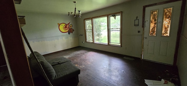 113 Brook St, Mc Ewen, TN 37101 - unfurnished dining area with wood finished floors, baseboards, a chandelier, and a wainscoted wall