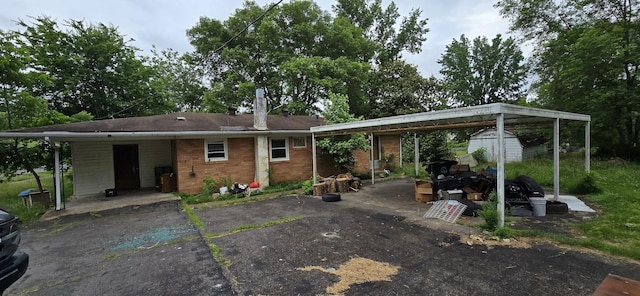 113 Brook St, Mc Ewen, TN 37101 - rear view of house with driveway, brick siding, and a carport
