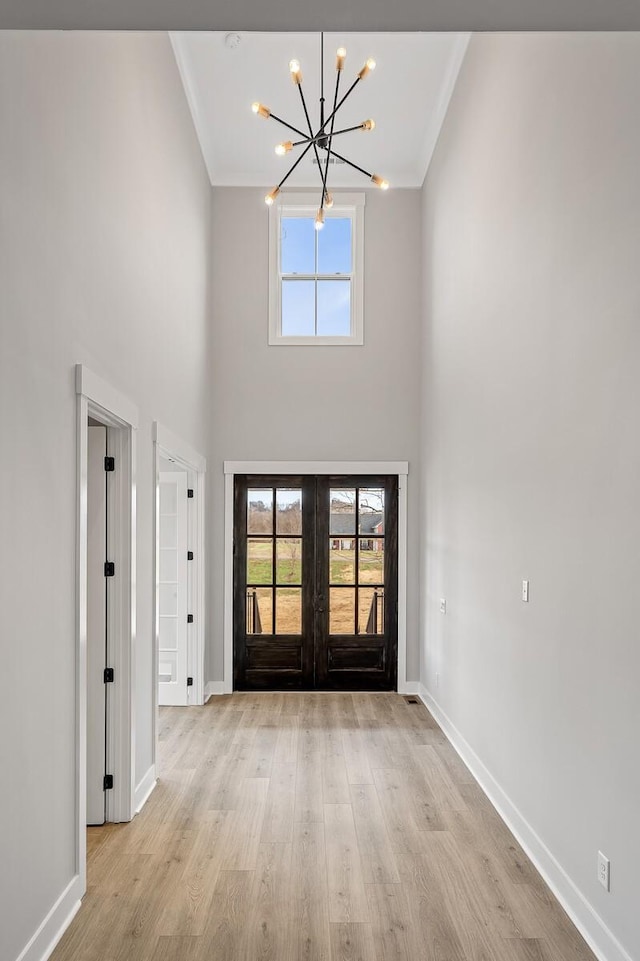 2736 Hartsville Pike, Castalian Springs, TN 37031 - entrance foyer with a chandelier, french doors, baseboards, crown molding, and a towering ceiling