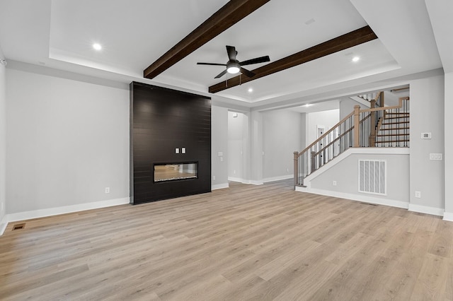 2736 Hartsville Pike, Castalian Springs, TN 37031 - unfurnished living room featuring a ceiling fan, light wood-type flooring, stairway, baseboards, and beam ceiling