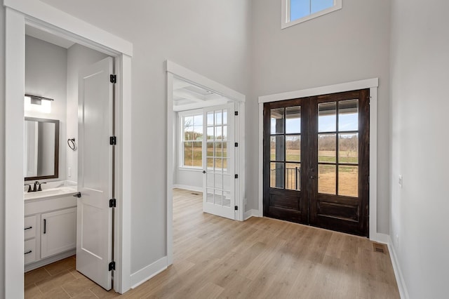 2736 Hartsville Pike, Castalian Springs, TN 37031 - foyer entrance with french doors, baseboards, light wood finished floors, and a high ceiling