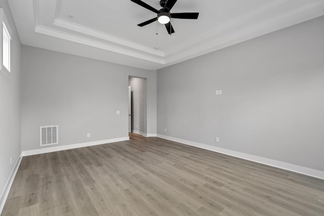 2736 Hartsville Pike, Castalian Springs, TN 37031 - empty room with a raised ceiling, ceiling fan, wood finished floors, baseboards, and ornamental molding