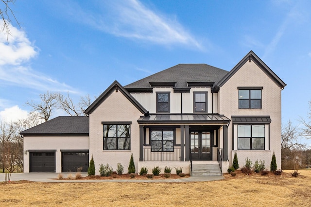 2736 Hartsville Pike, Castalian Springs, TN 37031 - modern farmhouse featuring covered porch, brick siding, an attached garage, and concrete driveway