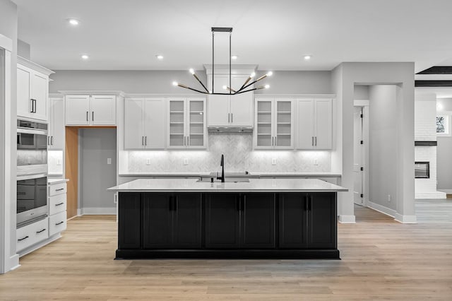 2736 Hartsville Pike, Castalian Springs, TN 37031 - kitchen with stainless steel double oven, a sink, white cabinets, light countertops, and recessed lighting