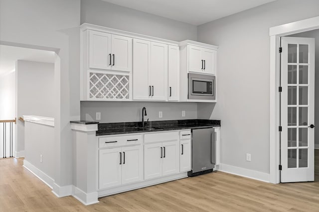 2736 Hartsville Pike, Castalian Springs, TN 37031 - kitchen with a sink, refrigerator, light wood-style floors, and dark stone countertops