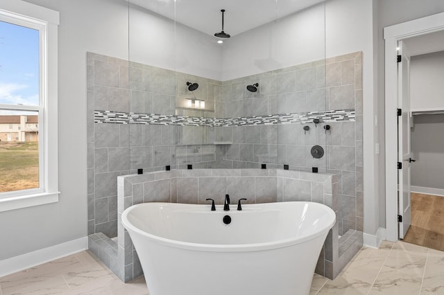 2736 Hartsville Pike, Castalian Springs, TN 37031 - full bath with marble look tiles, a freestanding bath, and plenty of natural light
