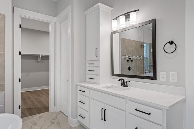 2736 Hartsville Pike, Castalian Springs, TN 37031 - full bathroom featuring vanity, tiled shower, a walk in closet, marble look tiles, and baseboards