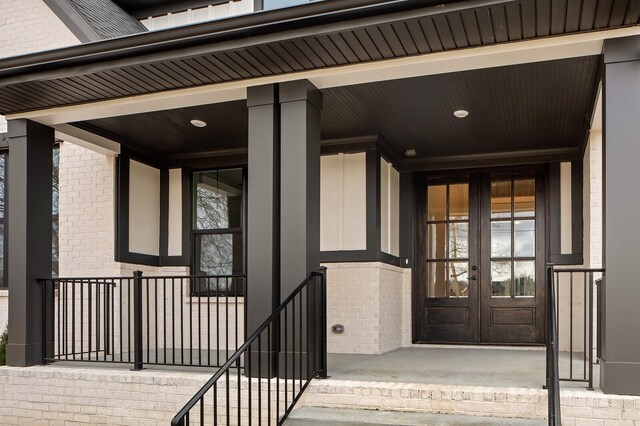 2736 Hartsville Pike, Castalian Springs, TN 37031 - view of exterior entry featuring french doors, brick siding, and a porch