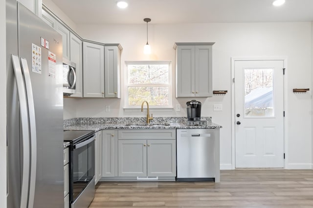 2800 N Hurricane Creek Rd, Mc Ewen, TN 37101 - kitchen featuring stainless steel appliances, a sink, gray cabinetry, light stone counters, and light wood-type flooring
