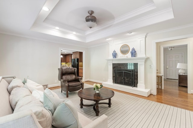 6116 Chickering Ct, Nashville, TN 37215 - living room with a tray ceiling, light wood-style floors, a high end fireplace, crown molding, and ceiling fan