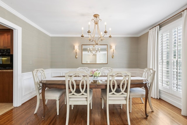 6116 Chickering Ct, Nashville, TN 37215 - dining room featuring healthy amount of natural light, a chandelier, light wood-style floors, wallpapered walls, and ornamental molding