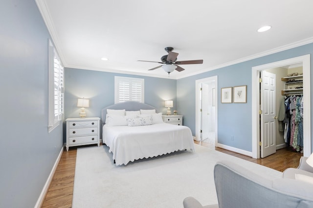 6116 Chickering Ct, Nashville, TN 37215 - bedroom featuring baseboards, wood finished floors, crown molding, recessed lighting, and a spacious closet