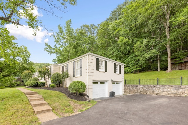 6116 Chickering Ct, Nashville, TN 37215 - view of home's exterior featuring asphalt driveway, an attached garage, and central AC