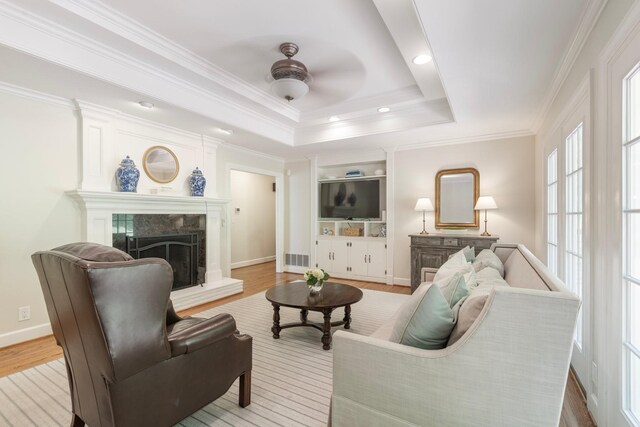 6116 Chickering Ct, Nashville, TN 37215 - living room featuring a fireplace, wood finished floors, ceiling fan, baseboards, and crown molding