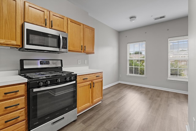 3401 Anderson Rd Unit 72, Antioch, TN 37013 - kitchen featuring appliances with stainless steel finishes, light wood-style floors, light countertops, and baseboards