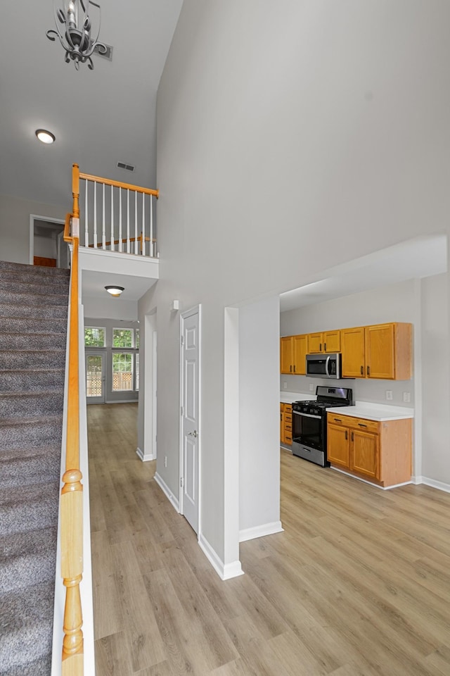3401 Anderson Rd Unit 72, Antioch, TN 37013 - stairs with high vaulted ceiling, wood finished floors, baseboards, and a chandelier