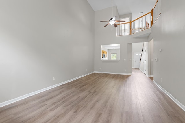 3401 Anderson Rd Unit 72, Antioch, TN 37013 - unfurnished living room with ceiling fan, wood finished floors, baseboards, and a towering ceiling