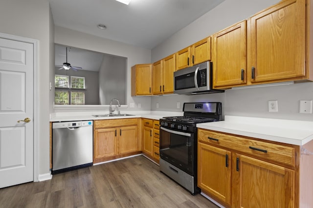 3401 Anderson Rd Unit 72, Antioch, TN 37013 - kitchen with stainless steel appliances, a sink, dark wood-style floors, light countertops, and ceiling fan