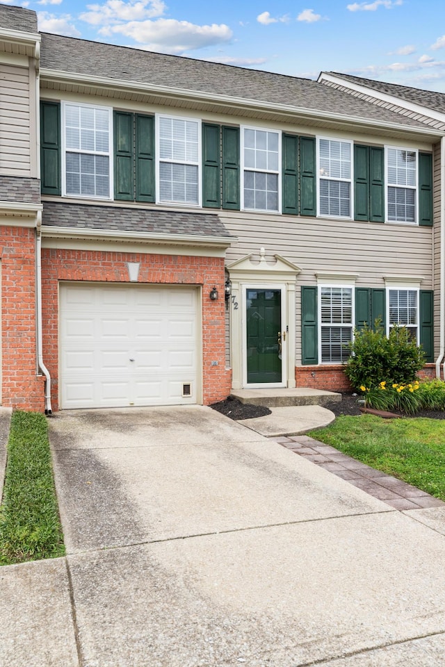 3401 Anderson Rd Unit 72, Antioch, TN 37013 - townhome / multi-family property with an attached garage, brick siding, and concrete driveway