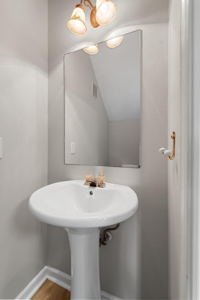 3401 Anderson Rd Unit 72, Antioch, TN 37013 - bathroom with baseboards, vaulted ceiling, wood finished floors, and a sink