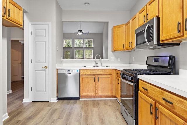 3401 Anderson Rd Unit 72, Antioch, TN 37013 - kitchen with stainless steel appliances, a sink, ceiling fan, light wood finished floors, and light countertops