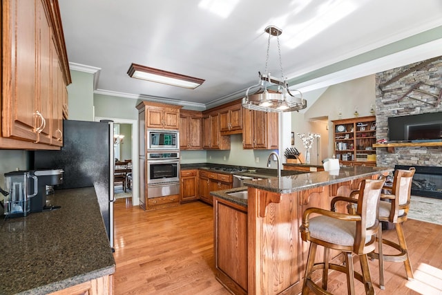 500 Old Pencil Mill Rd, Chapel Hill, TN 37034 - kitchen with appliances with stainless steel finishes, a warming drawer, brown cabinetry, light wood-type flooring, and ornamental molding