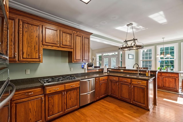 500 Old Pencil Mill Rd, Chapel Hill, TN 37034 - kitchen featuring a sink, light wood-style flooring, appliances with stainless steel finishes, brown cabinets, and crown molding