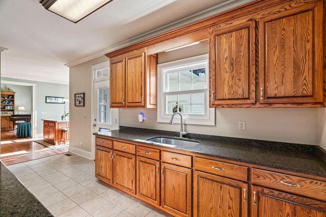 500 Old Pencil Mill Rd, Chapel Hill, TN 37034 - kitchen featuring a sink, brown cabinetry, light tile patterned floors, dark countertops, and ornamental molding