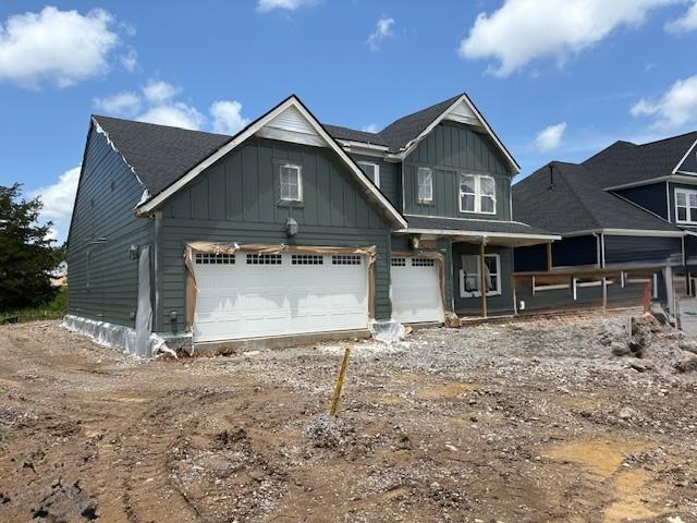 1070 Inez Dr, Smyrna, TN 37167 - view of front facade with board and batten siding, driveway, and an attached garage