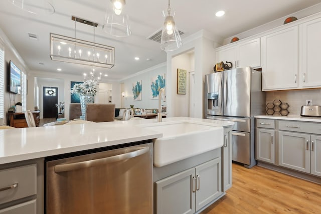3617 Anthony Ave, Murfreesboro, TN 37129 - kitchen with appliances with stainless steel finishes, gray cabinets, a sink, ornamental molding, and light countertops