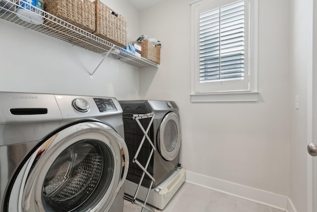 3617 Anthony Ave, Murfreesboro, TN 37129 - laundry area with washing machine and clothes dryer, baseboards, and light tile patterned floors