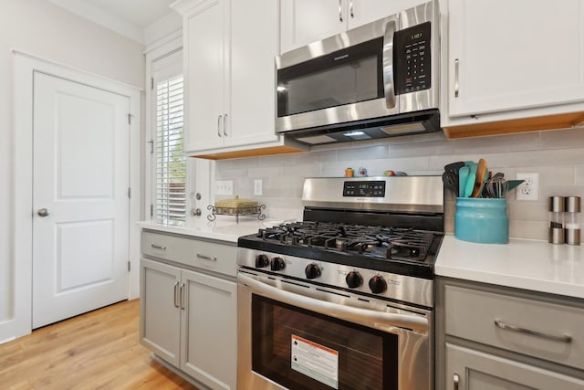 3617 Anthony Ave, Murfreesboro, TN 37129 - kitchen featuring stainless steel appliances, light countertops, tasteful backsplash, light wood-style floors, and gray cabinets
