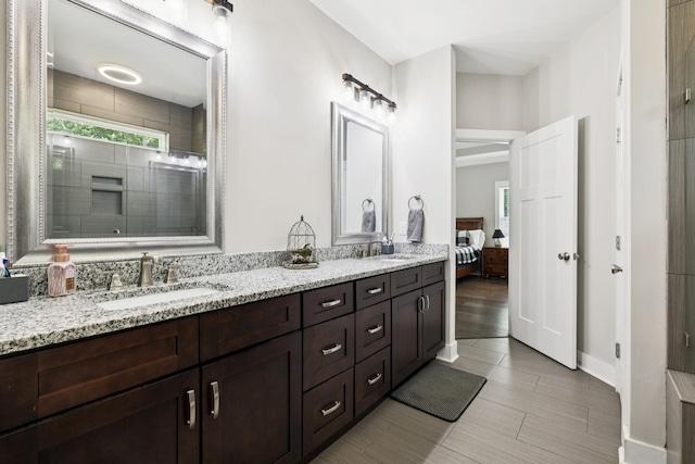 121 Regency Ln, Dickson, TN 37055 - ensuite bathroom with double vanity, plenty of natural light, a tile shower, and baseboards