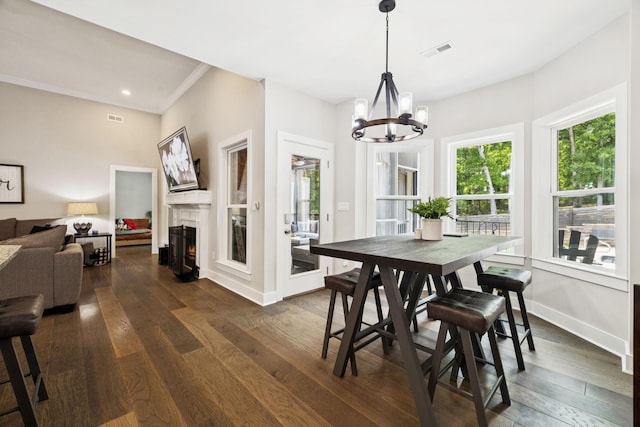 121 Regency Ln, Dickson, TN 37055 - dining space featuring a chandelier, dark wood-type flooring, baseboards, a warm lit fireplace, and ornamental molding