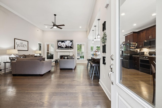 121 Regency Ln, Dickson, TN 37055 - living area with ceiling fan, ornamental molding, a glass covered fireplace, recessed lighting, and dark wood-style flooring