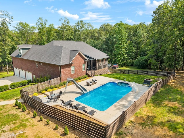121 Regency Ln, Dickson, TN 37055 - view of swimming pool with a water slide, a sunroom, a patio area, and an outdoor living space