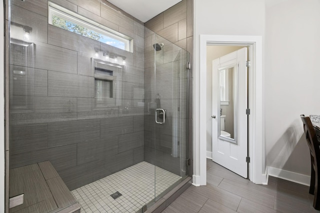 121 Regency Ln, Dickson, TN 37055 - bathroom with a shower stall, baseboards, toilet, and vanity
